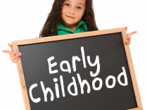 Girl holding sign that says early childhood
